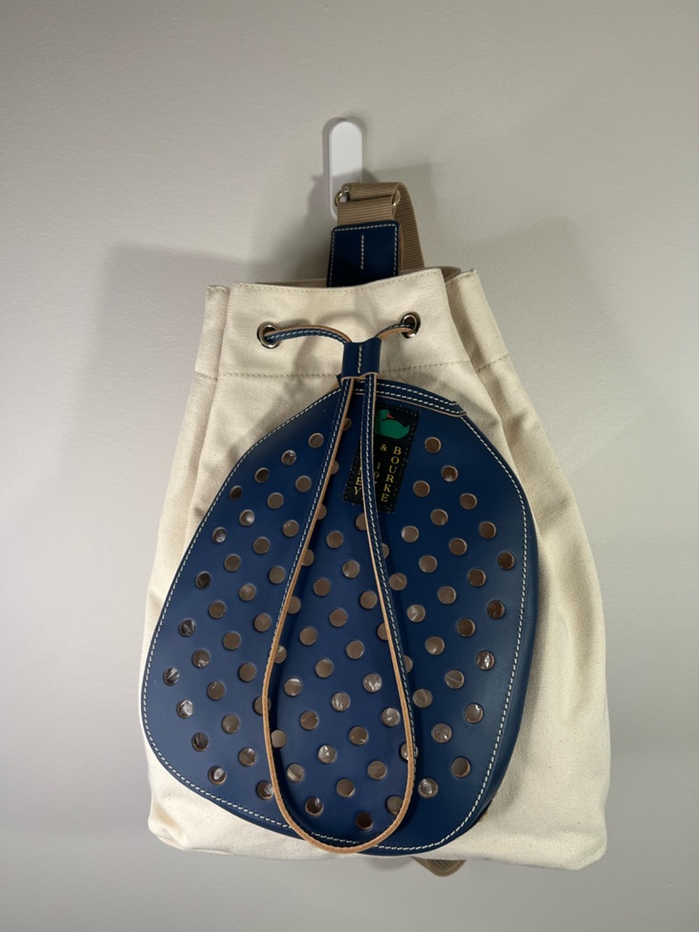 Dooney & Bourke Canvas Pickleball Sling Backpack in Tan and Navy Blue